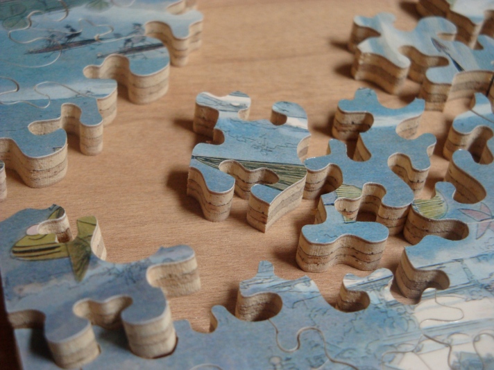 close_up_of_hand_cut_jigsaw_puzzle